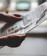 Person reading a newspaper